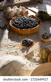 Process Of Making Dough For Blueberry Pie. Eggs, Flour And Berries In The Sunlight.