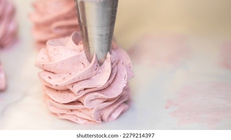 the process of making fruit marshmallow. the confectioner squeezes the marshmallow mass through the nozzle. home bakery concept.