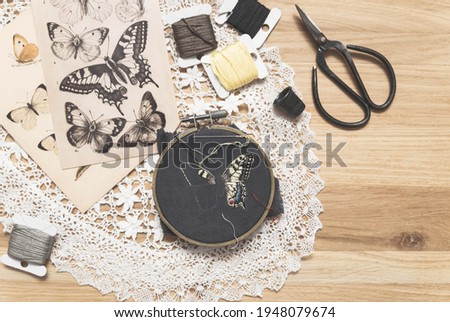 Process of making handmade embroidery. Hobby. Sewing tools. Remote home work. Swallowtail butterfly.