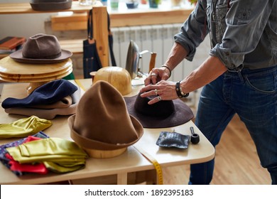 the process of making hats for customer, maintenance and crafting sewing clothes concept. designer male giving shape to hat in workshop - Powered by Shutterstock