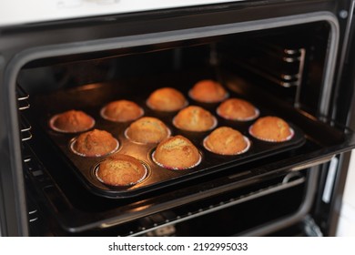 The process of making homemade cupcakes, top view. Baked muffins in the oven.Step six