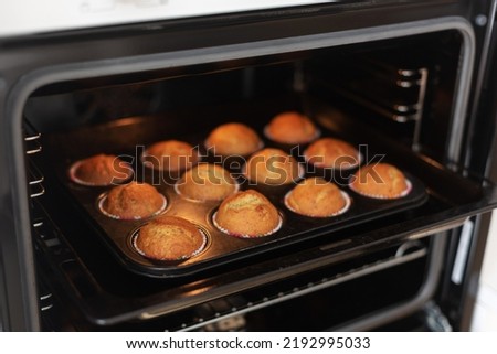 The process of making homemade cupcakes, top view. Baked muffins in the oven.Step six