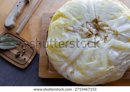 Process of making homemade stuffed cabbage rolls with minced meat, rice and spices in a cozy home kitchen. Traditional comfort food preparation, step by step cooking concept. High quality photo