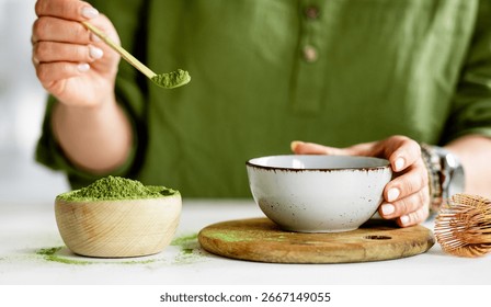 Process Of Making Matcha Tea Involves A Woman Pouring Tea Into A Bowl