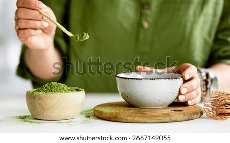 Process Of Making Matcha Tea Involves A Woman Pouring Tea Into A Bowl
