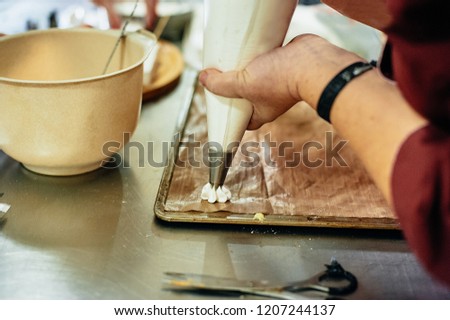 Process of making meringue pavlova dessert Food industry, mass or volume production. pastry chef making dessert.