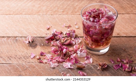 process of making onion peel fertilizer, onion skin soaked in water with scattered pieces, food waste used as natural fertilizer, kitchen and household waste management concept with copy space