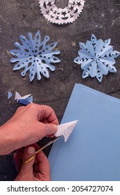 The Process Of Making Paper Snowflakes Flat Lay