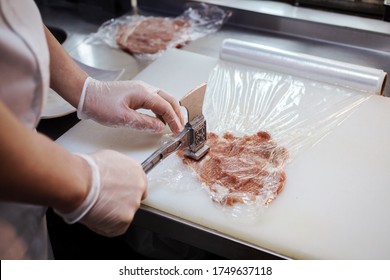 The process of making pork chop, cutlet indoors in the restaurant kitchen. Chef hands are in gloves.  - Shutterstock ID 1749637118