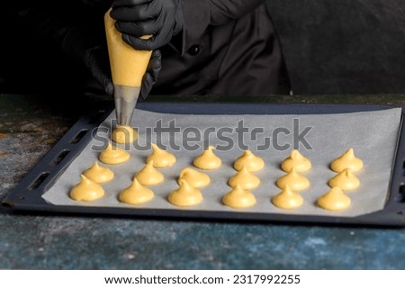 The process of making profiteroles using a cooking bag. Confectionery. Close up