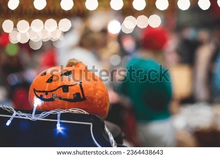 Process of making pumpkin lantern for halloween party, glowing jack-o-lantern carving master class on halloween fair market, orange decoration, illuminated carved pumpkin lanterns