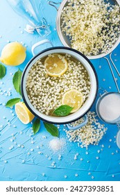 Process of making a summer drink, made from natural fermentation of elder flowers in water lemon and sugar. Preparation of an elder flower syrup from fresh elder flowers, honey, and lemon