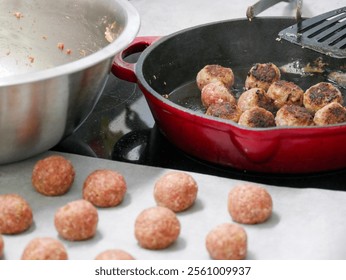 The process of making swedish meatballs. Raw meatballs cooking in a cast iron pan on the stove. Trasitional cuisine. Cooking in the kitchen. 