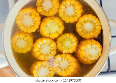 the process of making sweet corn in a pot on the gas stove at home.