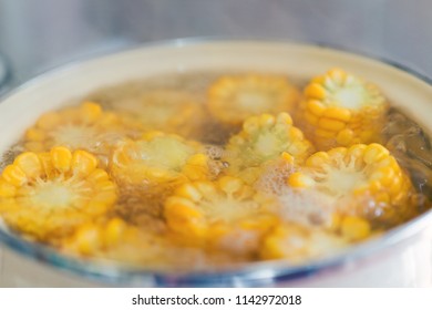 the process of making sweet corn in a pot on the gas stove at home.