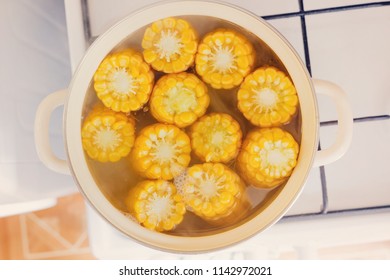 the process of making sweet corn in a pot on the gas stove at home.