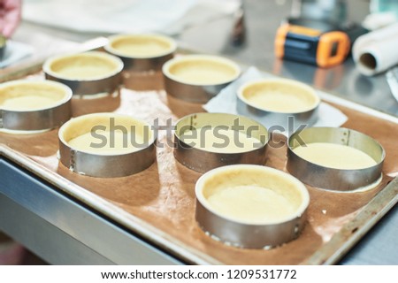 Process of making tart with salted caramel french dessert. Food industry, mass or volume production. pastry chef making dessert