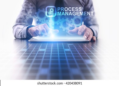 Process management concept. Businessman using futuristic tablet computer, pressing button on the touch screen and selecting Process management. 