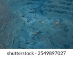 The process of open-pit mining in a quarry for the extraction of minerals. Open pit mining of iron ore with the help of large equipment, the bowl of the pit 