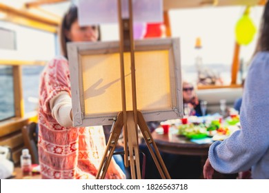 Process of painting, group class of adult talented students with paints easels, and canvases during lesson of watercolour painting outdoors  - Powered by Shutterstock