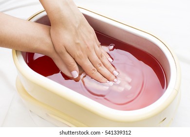 process paraffin treatment of female hands in beauty salon