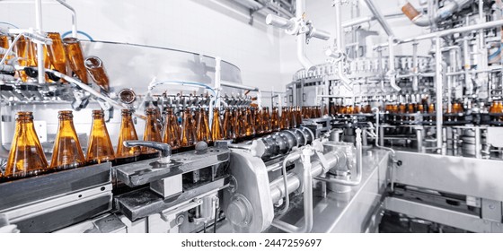 Process pasteurization Brown glasses bottles with beer, moving on conveyor. Concept production line of brewery, modern food industry. - Powered by Shutterstock