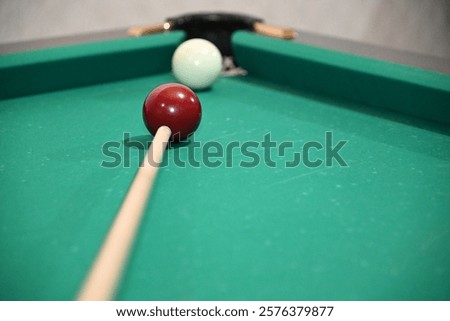 The process of playing billiards with a cue in hand at the billiard table of Russian billiards