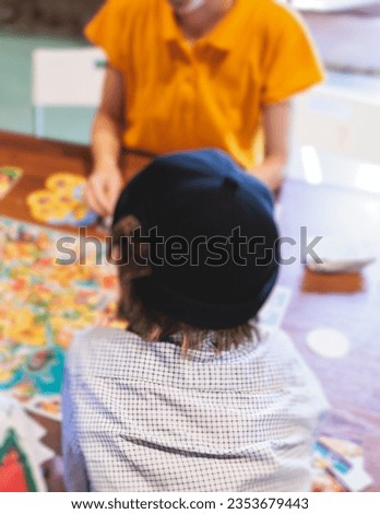 Process of playing board game and having fun with friends and family in room indoors, board game concept, group of kids children play board games at the table, roll the dice 