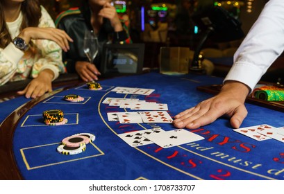 the process of playing casino at the tables. hands of the croupier. hands of players. cards and chips