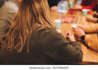 Process of playing tabletop board game on the table, fun with friends and family in room indoors, board game party concept, company group of students adults play board games, roll the dice on game map