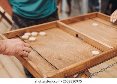Process of playing tabletop board game on the table, fun with friends and family in room indoors, board game party concept, company group of students adults play board games, roll the dice on game map