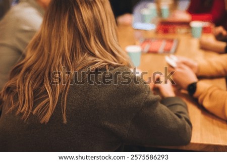 Process of playing tabletop board game on the table, fun with friends and family in room indoors, board game party concept, company group of students adults play board games, roll the dice on game map