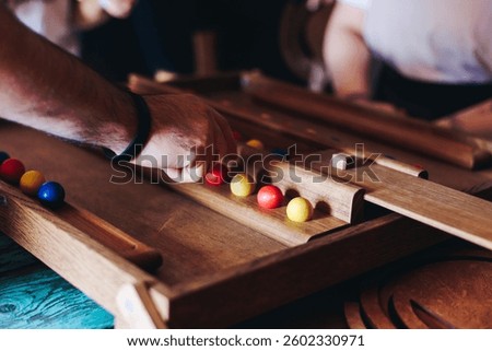 Process of playing tabletop board game on the table, fun with friends and family in room indoors, board game party concept, company group of students adults play board games, roll the dice on game map