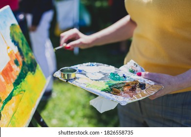 Process of plein air painting, group class of adult talented students in the park with paints easels, and canvases during lesson of watercolour painting outdoors  - Powered by Shutterstock