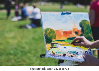 Process of plein air painting, group class of adult talented students in the park with paints easels, and canvases during lesson of watercolour painting outdoors  - Powered by Shutterstock