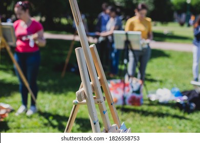 Process of plein air painting, group class of adult talented students in the park with paints easels, and canvases during lesson of watercolour painting outdoors  - Powered by Shutterstock