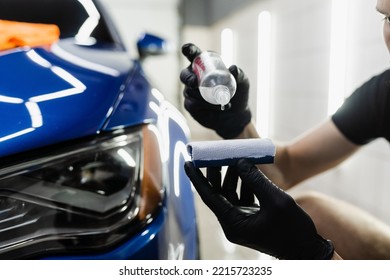Process of pouring ceramic liquid from bottle on sponge to apply a protective nano layer on car. Detailing service worker applies ceramic protective liquid on sponge close-up - Shutterstock ID 2215723235