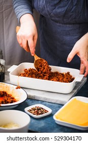 Process Of Preparing Tasty Lasagna With Beef Minced Meat And Vegetables. Woman Add Beef Minced Meat In Casserole. Stuffing Dish.