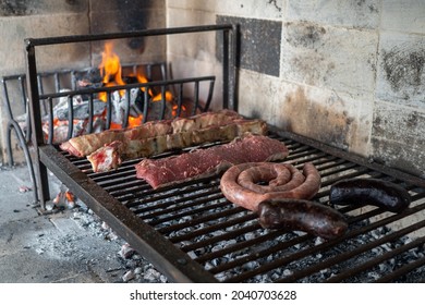 The process of preparing a typical Argentinian Asado with beef and sausage