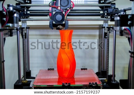 Process printing model on 3d printer. High tech digital printer computer machine in action. Printing mechanism adding layers to object. FDM 3d printer working at 3d printing lab. 3D modern technology.