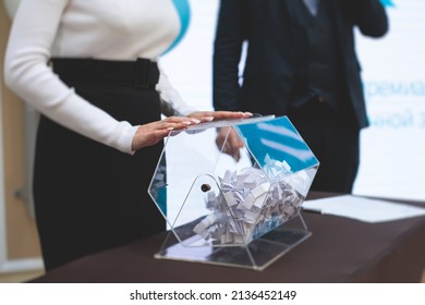 Process Of Prize Drawings, Extracting A Winning Numbers Of Lottery Machine, Raffle Drum With Bingo Balls And Winning Tickets On Event With A Host And Hands On Lottery Machine