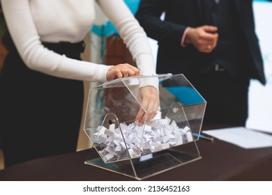 Process Of Prize Drawings, Extracting A Winning Numbers Of Lottery Machine, Raffle Drum With Bingo Balls And Winning Tickets On Event With A Host And Hands On Lottery Machine