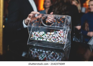 Process of prize drawings, extracting a winning numbers of lottery machine, raffle drum with a bingo balls and winning tickets on event with a host and hands on lottery machine
 - Shutterstock ID 2142375049