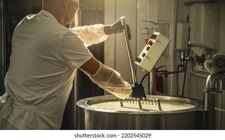 The process of producing different varieties of cheese in industry. Natural milk cheese making as a business - Powered by Shutterstock