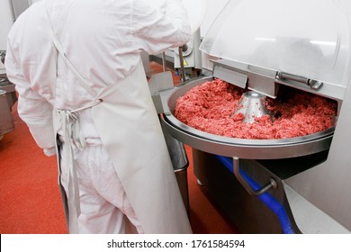 Process for the production of products of animal origin. Raw meat minced in an industrial process factory stored in a stainless steel crate at a processing.