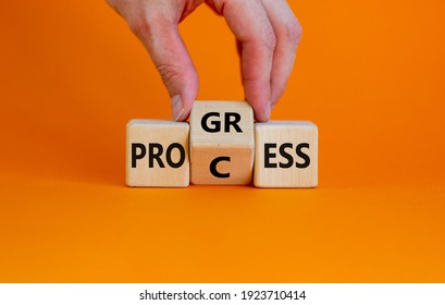 Process And Progress Symbol. Businessman Turns A Wooden Cube And Changes The Word 'process' To 'progress'. Beautiful Orange Background, Copy Space. Business, Process And Progress Concept.