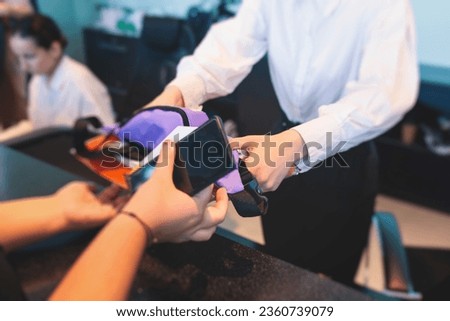 Process of receiving gift bag package for conference participants before start, with a leaflet handout, notebook notepad, t-shirt, mug, pen, pencil, corporate gifts and souvenirs for employees 