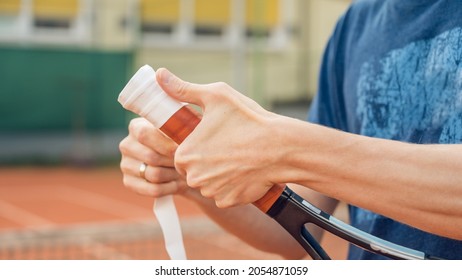 Process of replacement grip on tennis racket. Overgrip. Close-up of hands. - Shutterstock ID 2054871059