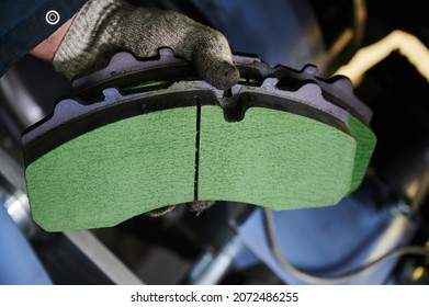 the process of replacing brake pads on a regular bus in a workshop, close-up