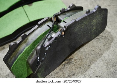 the process of replacing brake pads on a regular bus in a workshop, close-up